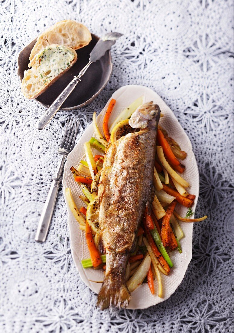Baked trout on a bed of vegetables