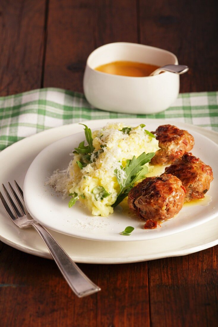 Meatballs with mashed potato and rocket