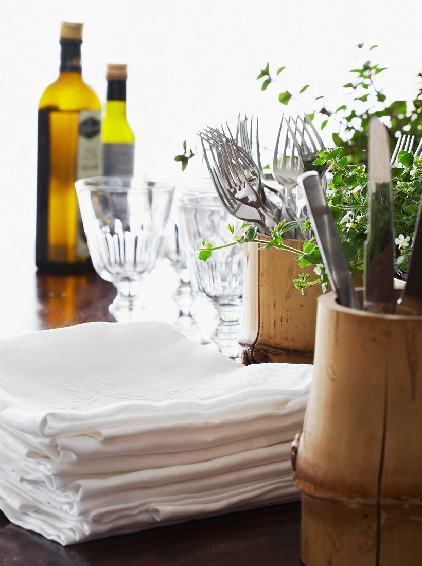 Napkins, cutlery and wine glasses on a table