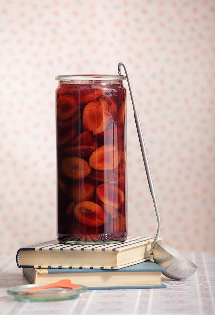 Stewed damsons with port in a preserving jar