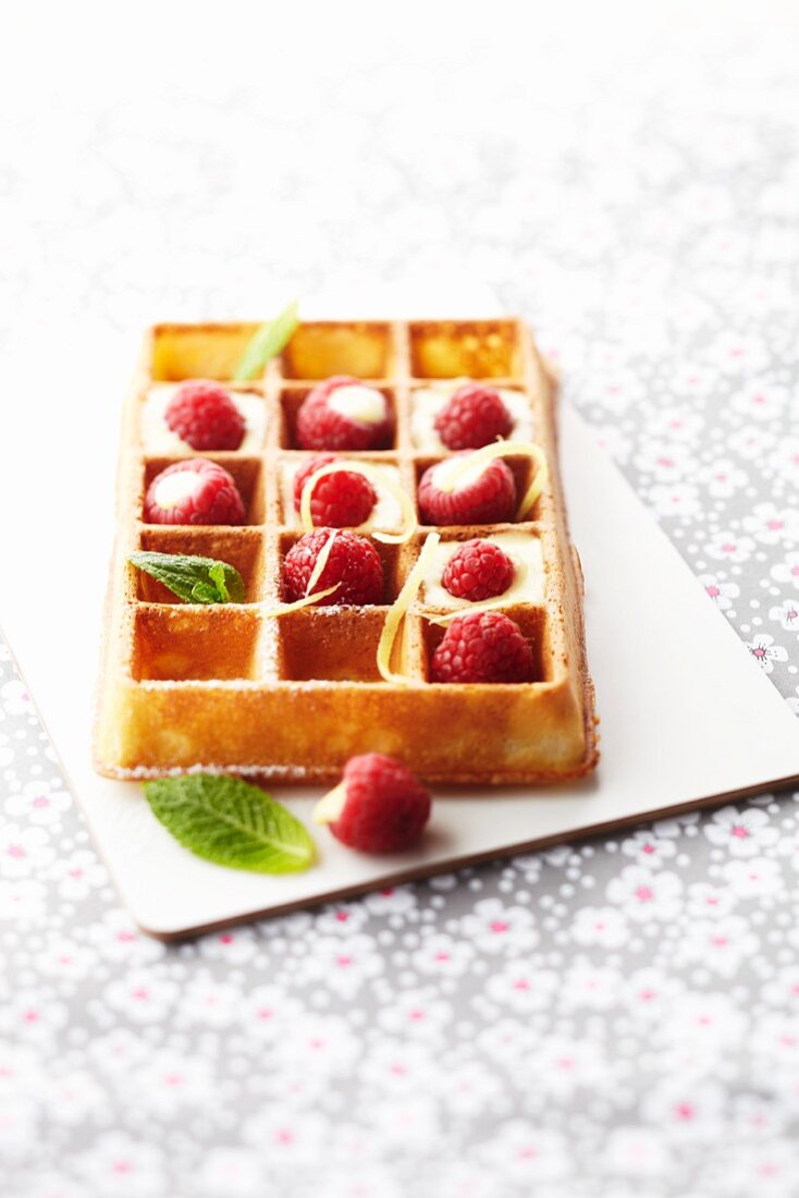 Waffle with lemon cream and fresh raspberries
