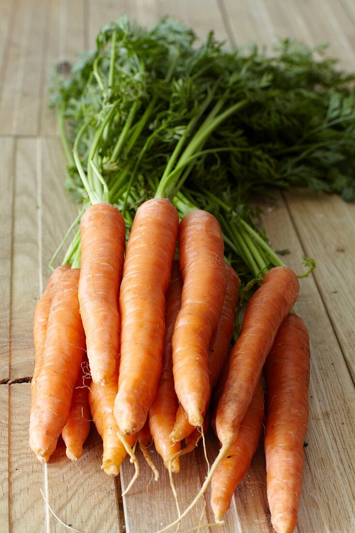 Fresh carrots on wooden planks