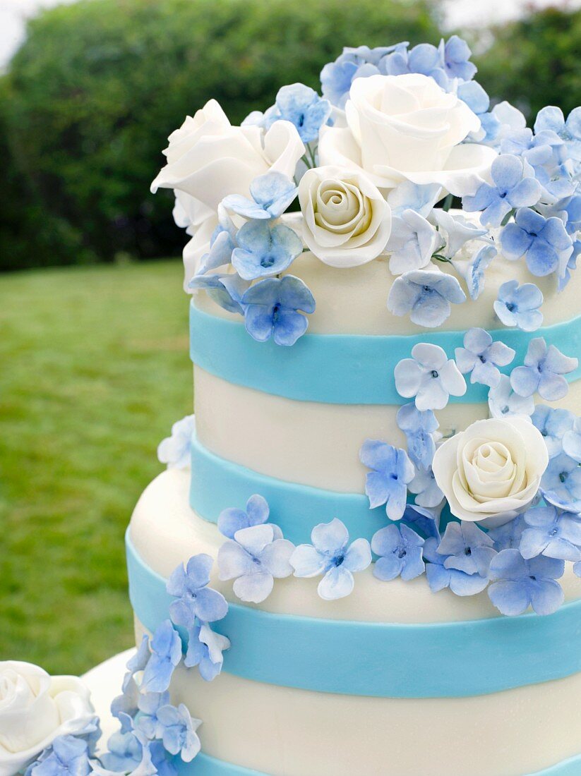Pretty Blue and White Wedding Cake on an Outdoor Table