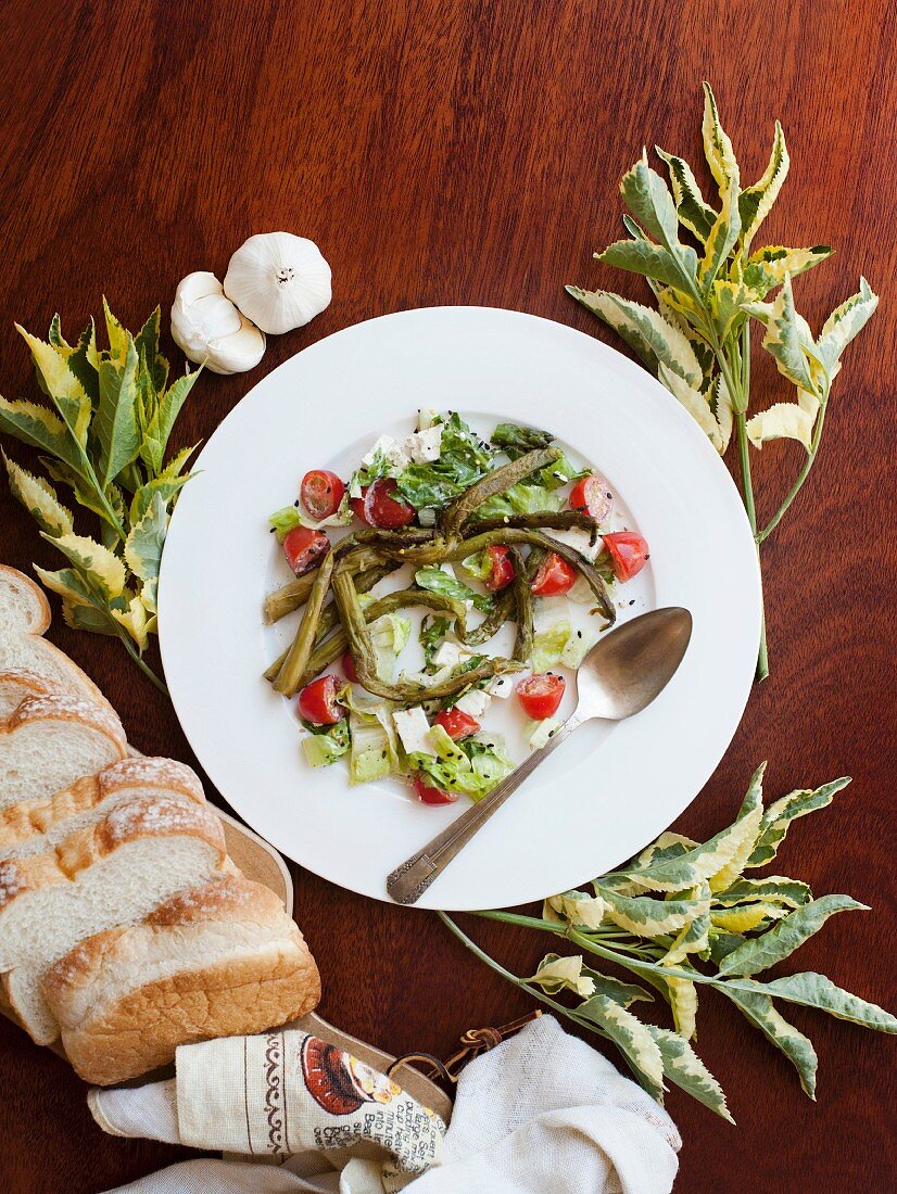 A salad of asparagus tomatoes, feta and bread