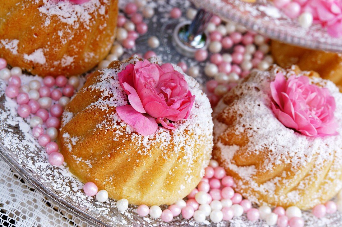 Small Bundt cakes with icing sugar and rose decoration
