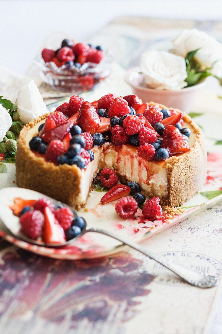 Cheesecake with berries, a piece removed