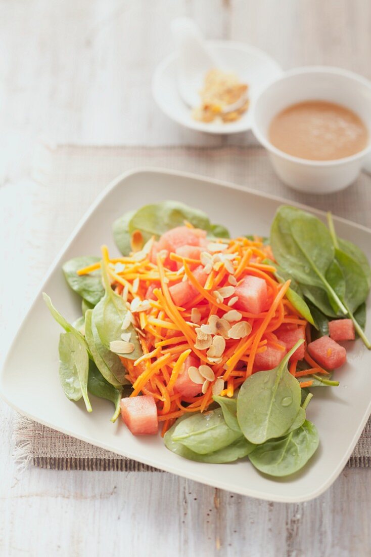 Watermelon & carrot salad with young spinach leaves