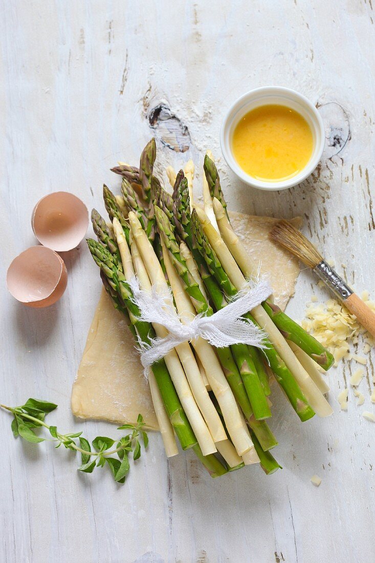 Green and White Asparagus Spears Bundled on Uncooked Pastry; Ingredients