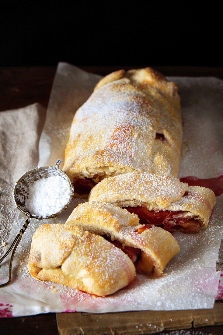 Peach strudel with icing sugar