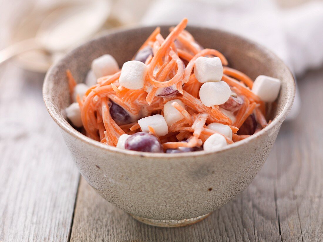 Carrot salad with grapes and marshmallows