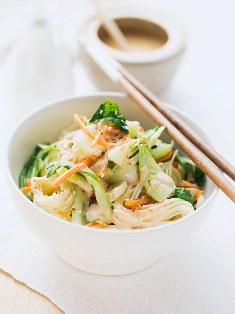 Rice noodles with carrots, pak choi and peanut sauce (Asia)