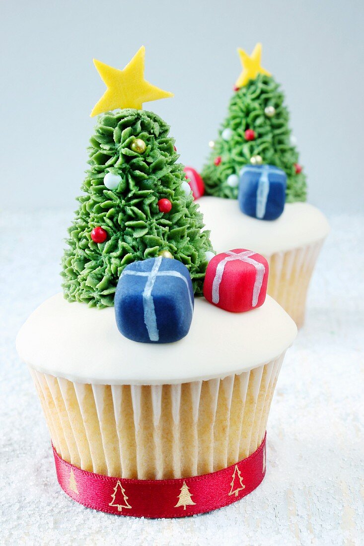 Christmassy cupcakes decorated with presents and Christmas trees