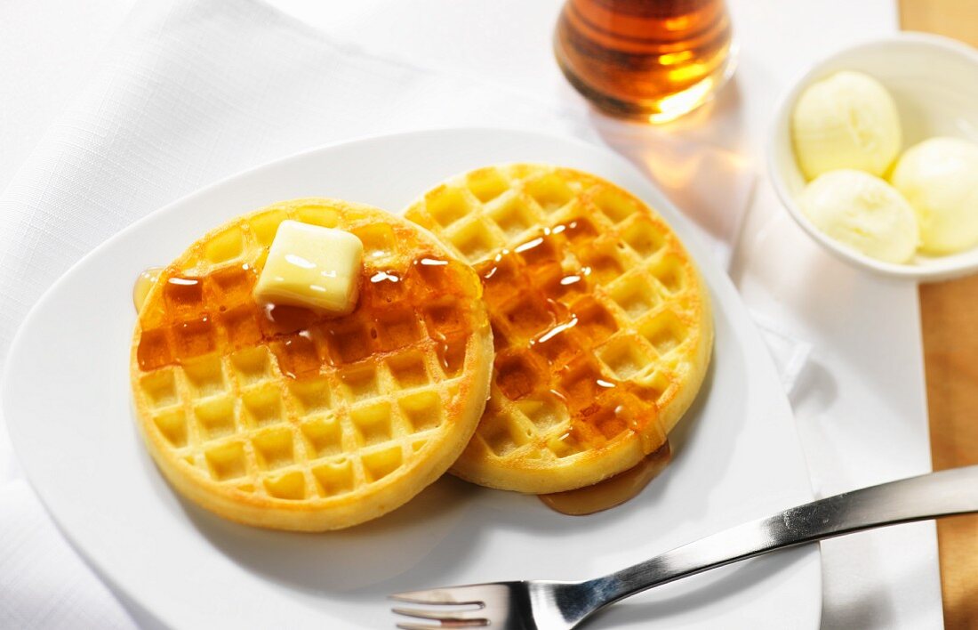 Waffles with butter and maple syrup for breakfast