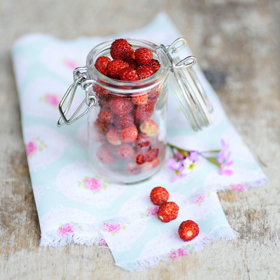 Wild strawberries in a preserving jar