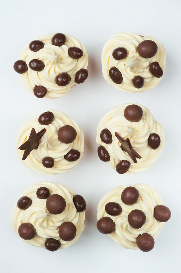 Cupcakes with cream icing and chocolate decoration