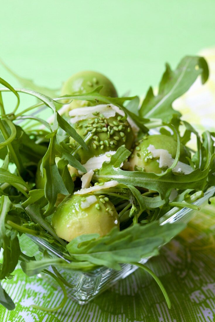 Rocket salad with avocado balls and wasabi sesame seeds