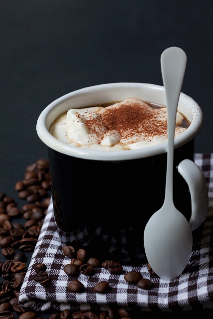 A cappuccino with cream in a mug