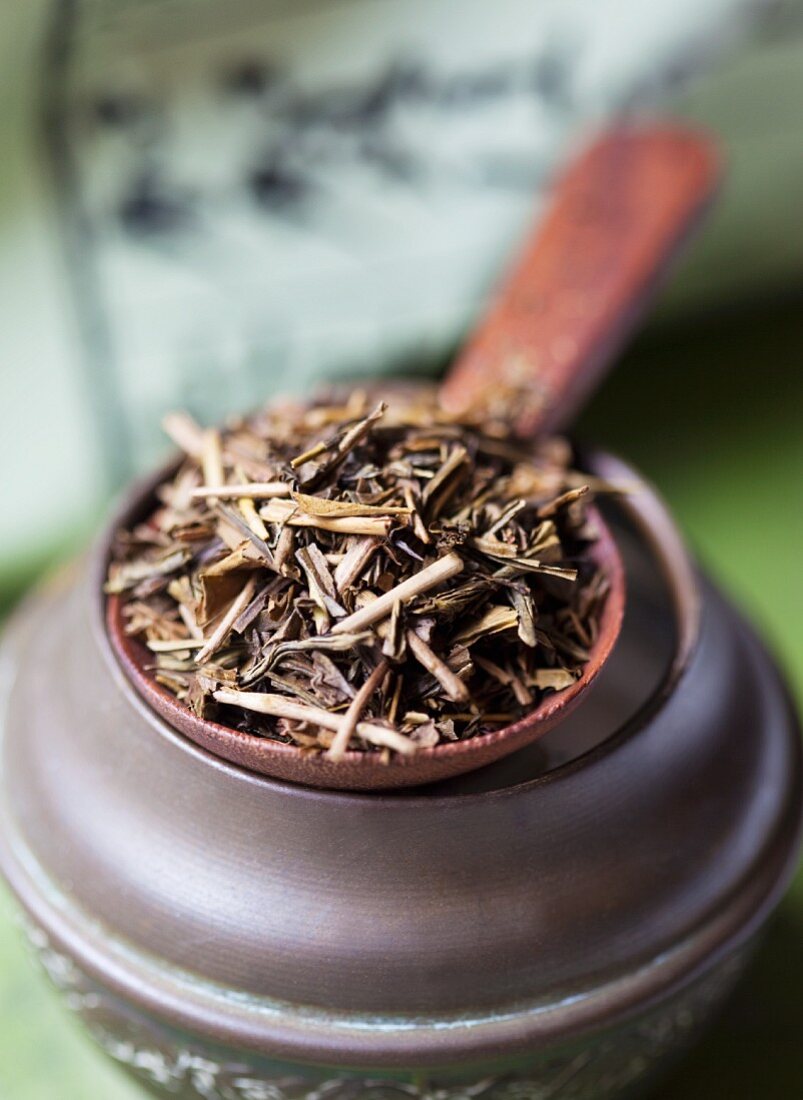 Japanese tea leaves on a wooden spoon