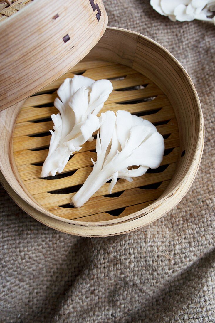 Oyster mushrooms in a bamboo steamer