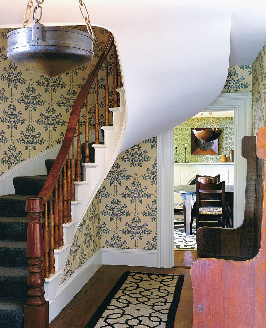 Curved stairway and entrance way with arts and crafts furnishungs in 18th century house