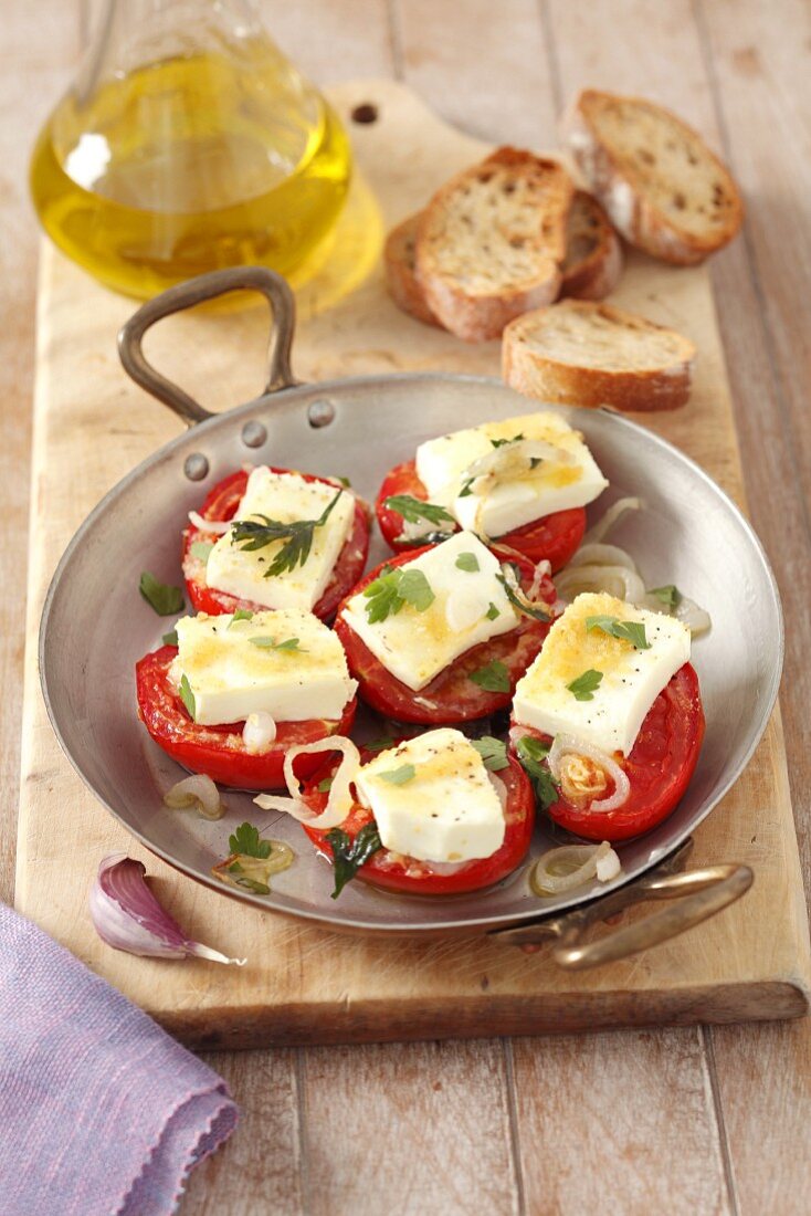 Baked tomatoes with ewe's cheese, herbs and olive oil