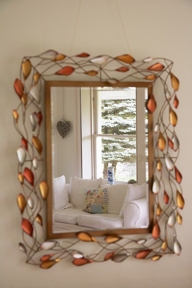 Sofa reflected in mirror with intricate glass ornamentation