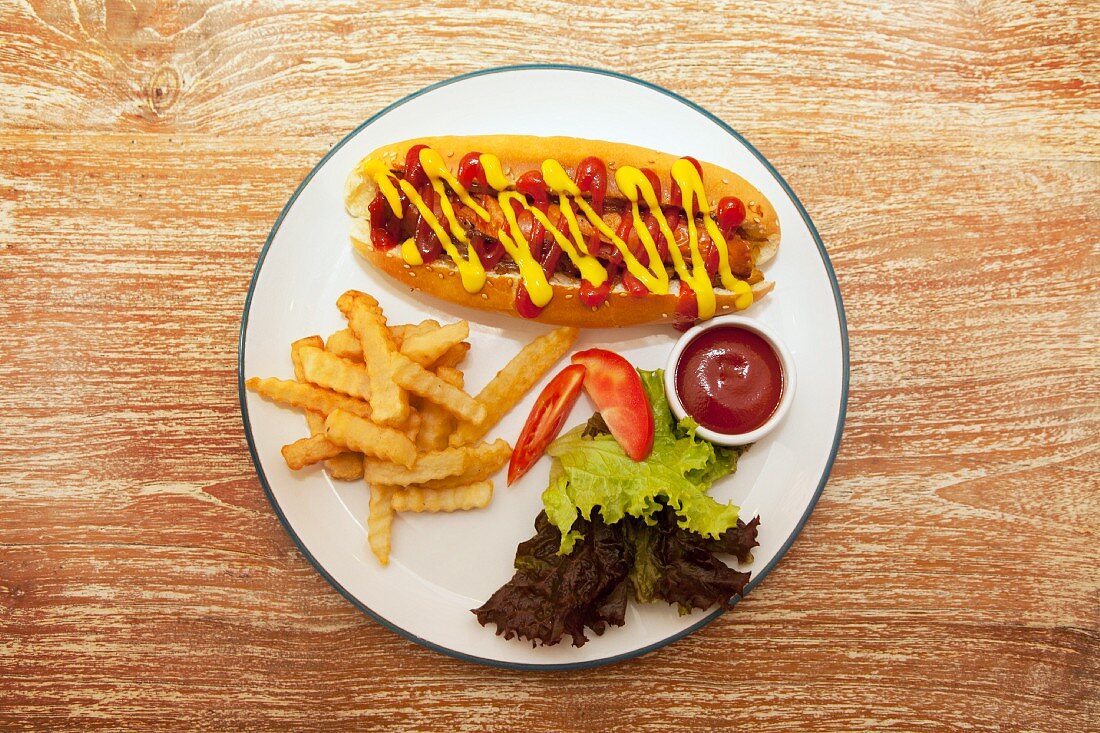 Hot dog with chips, ketchup and a side salad
