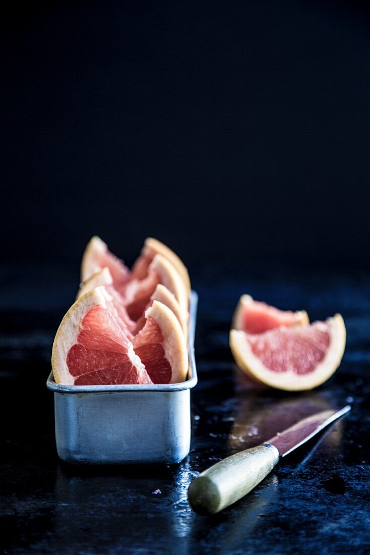 Grapefruit wedges in a metal container