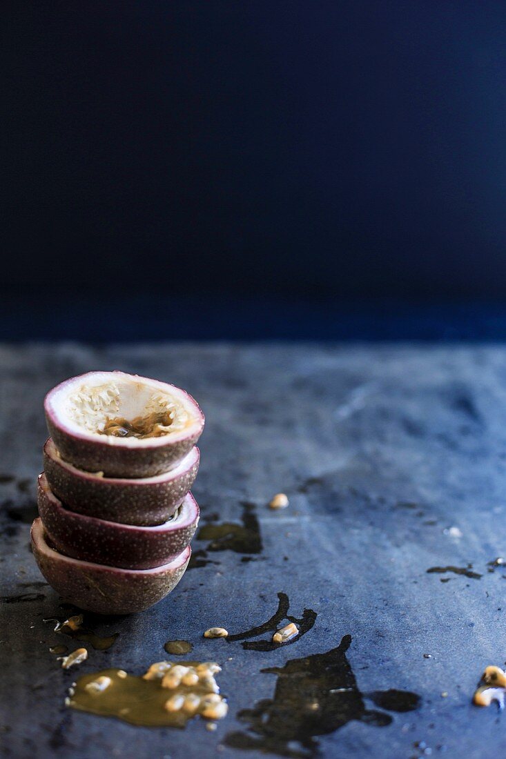 A stack of scooped-out passion fruit halves