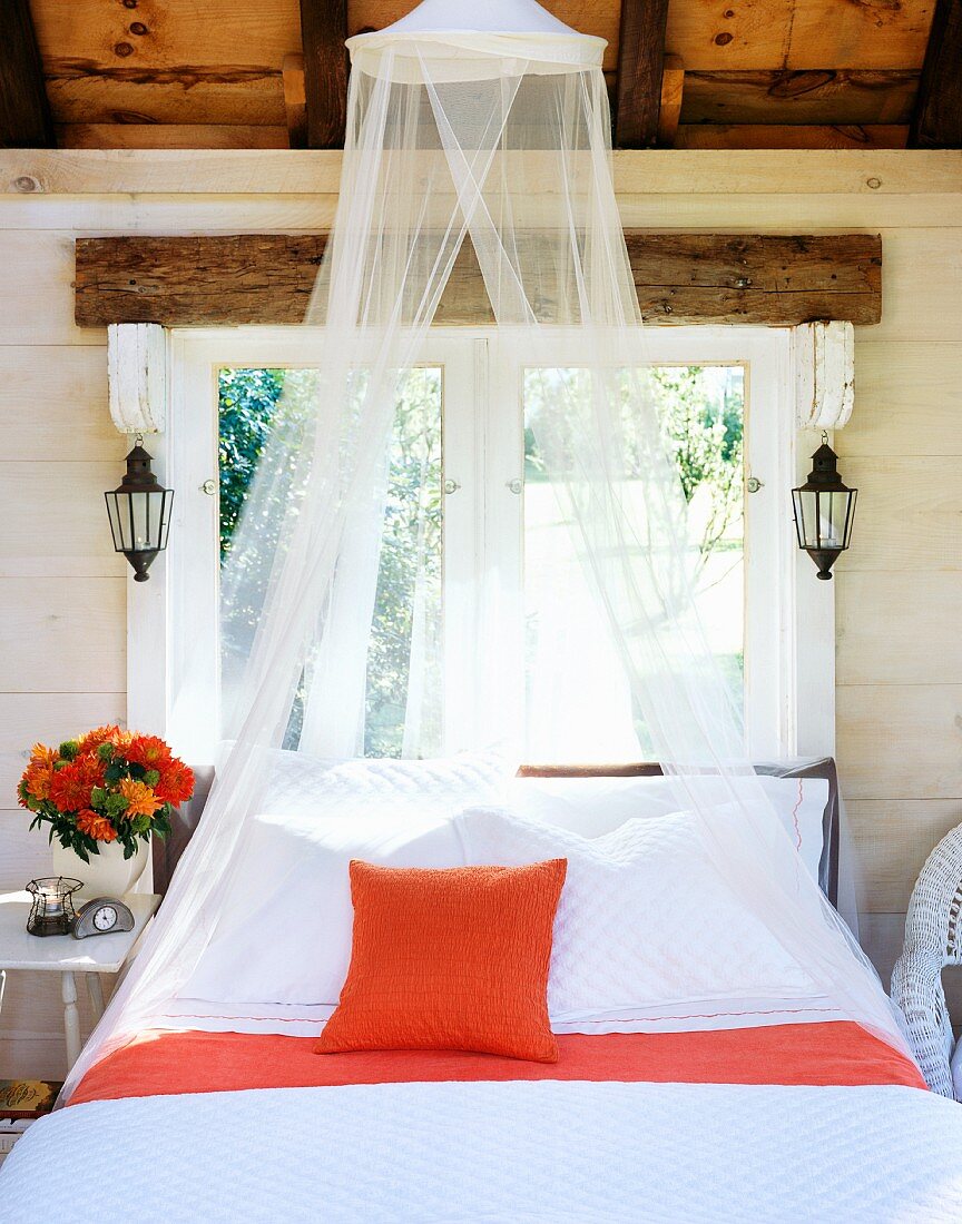 Well made bed with bug netting