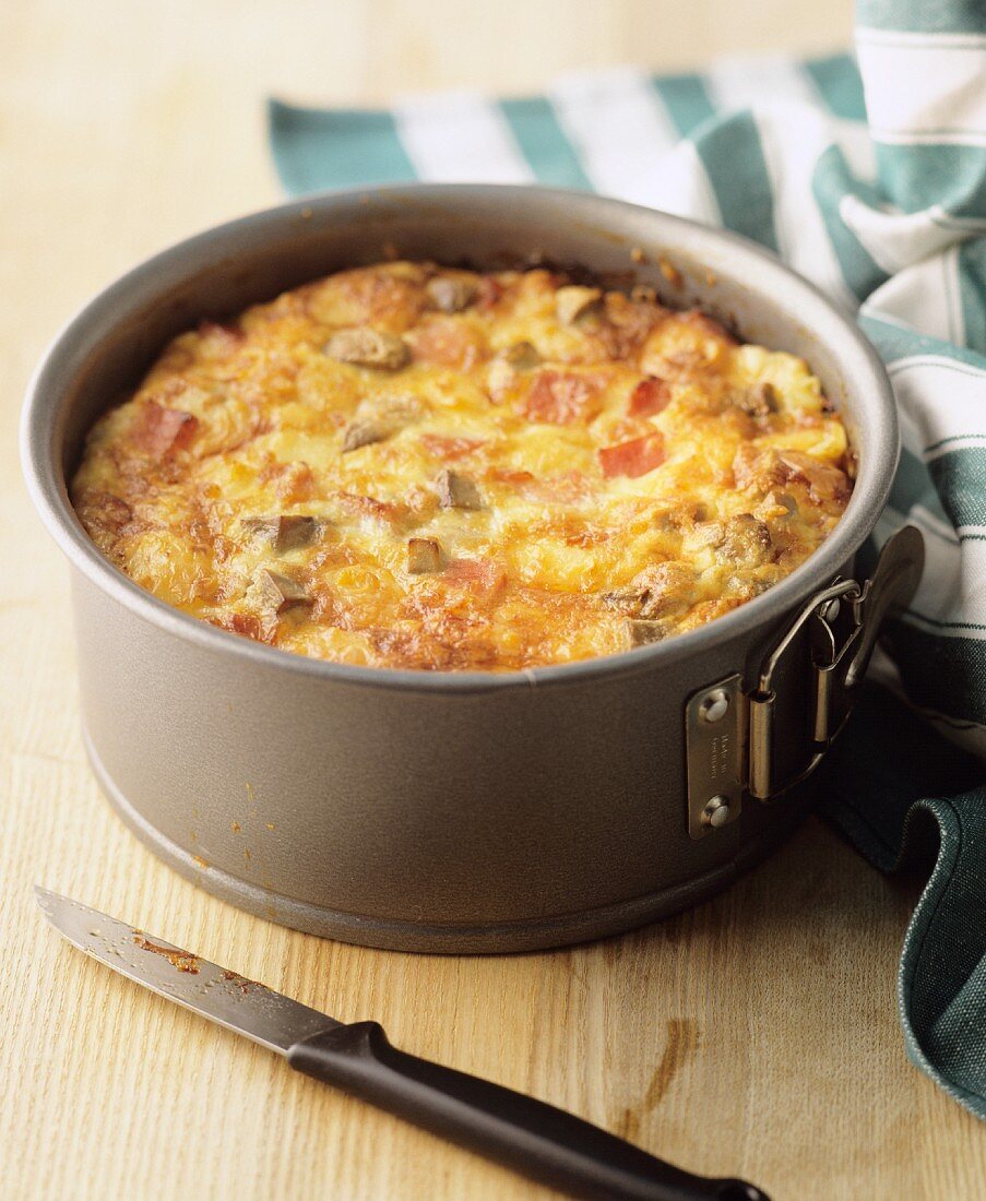 A small vegetable cake with bacon in a spring-form cake tin