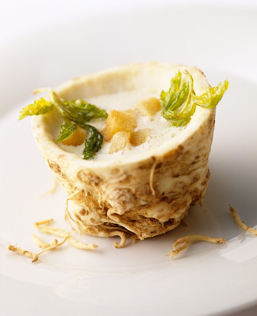 Cream of celeriac soup with croutons in a hollowed-out celeriac