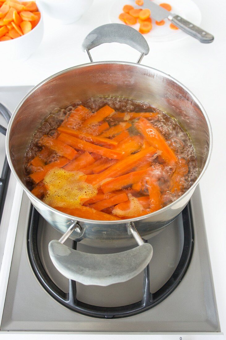 Carrots boiling on a gas hob