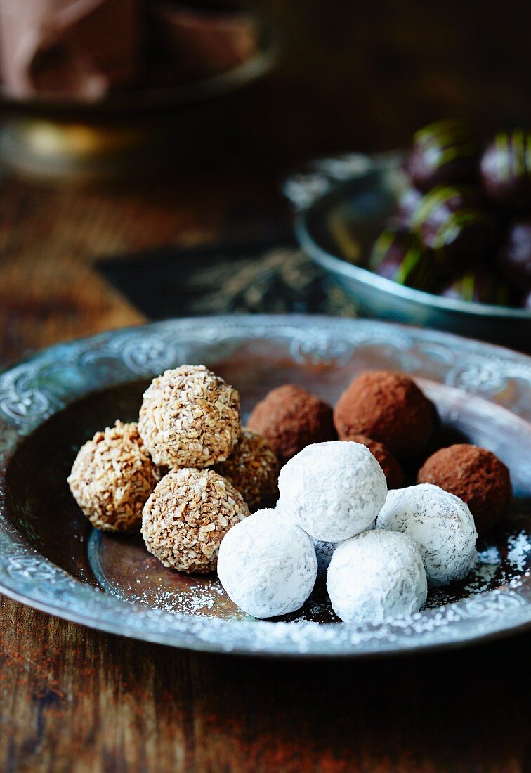Assorted chocolate truffles on a metal plate