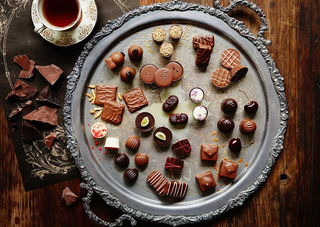 Assorted filled chocolates on an antique tray