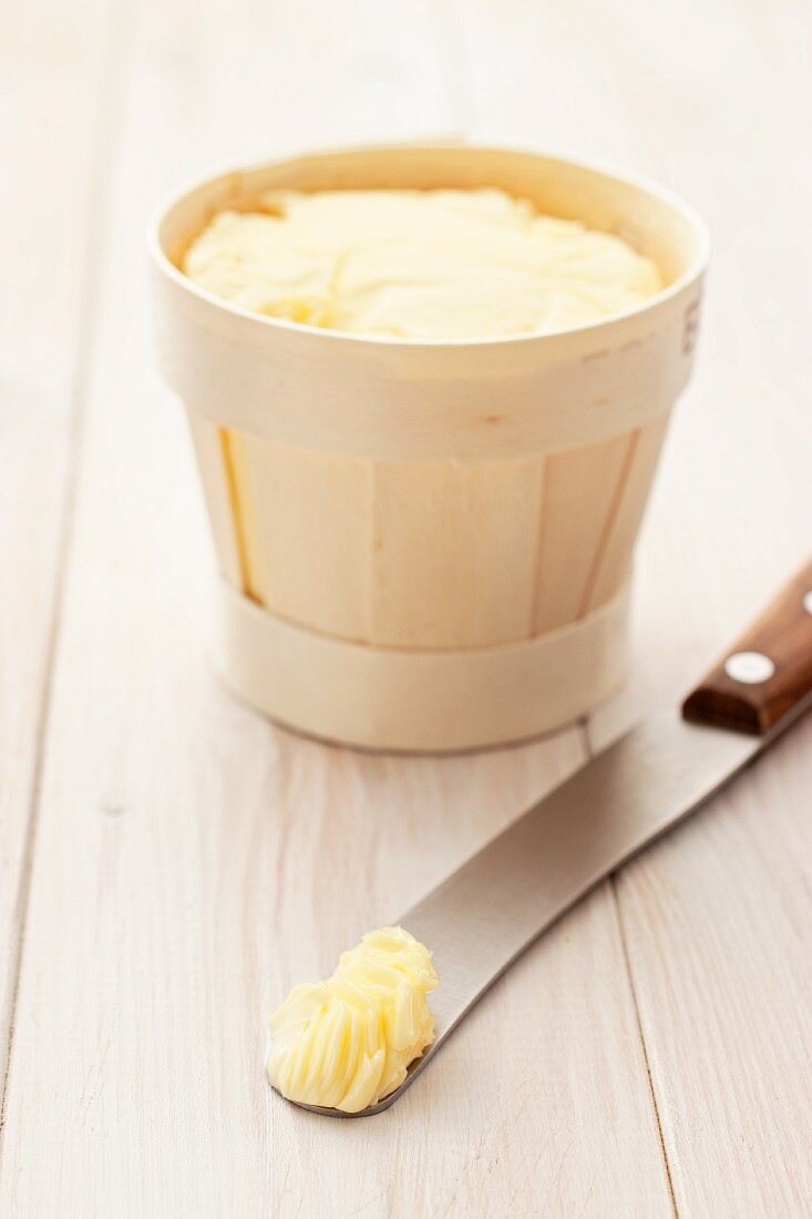 Butter in a wood-chip basket and on a knife