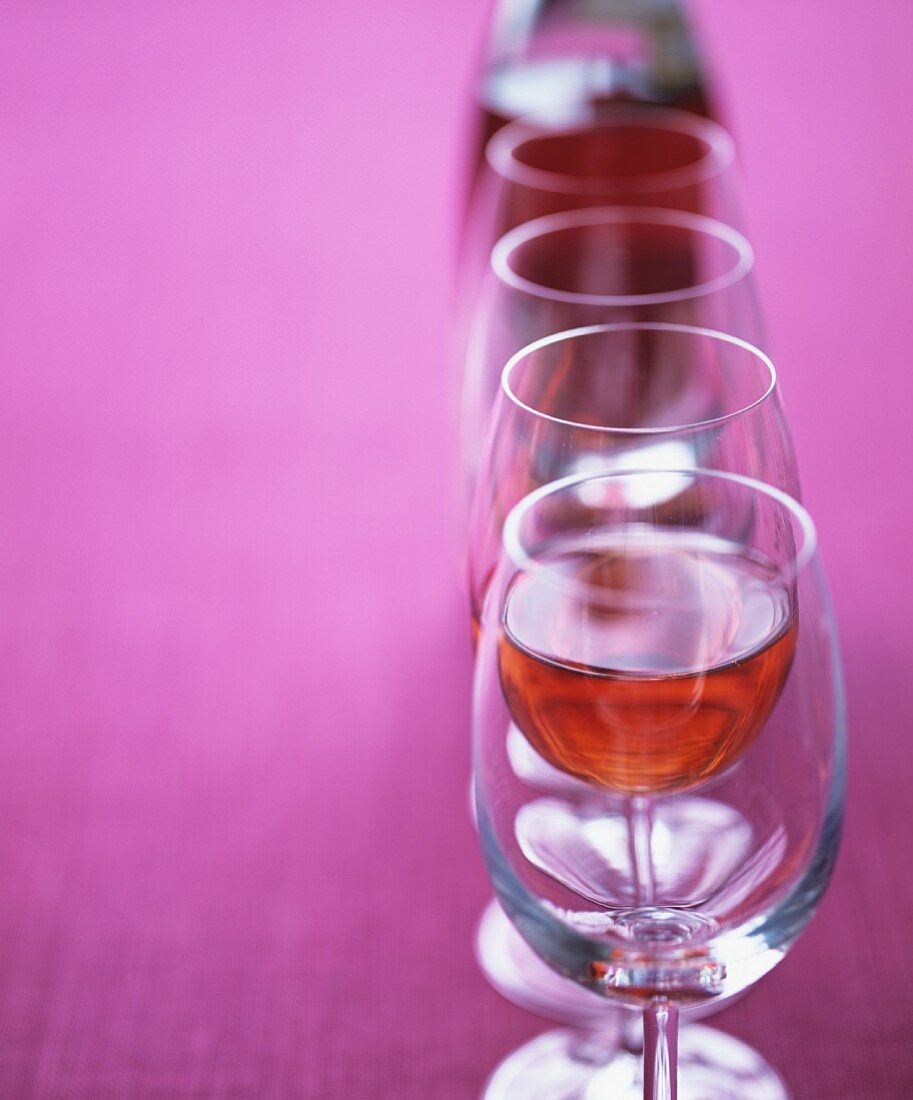 Rosé wine glasses in a row