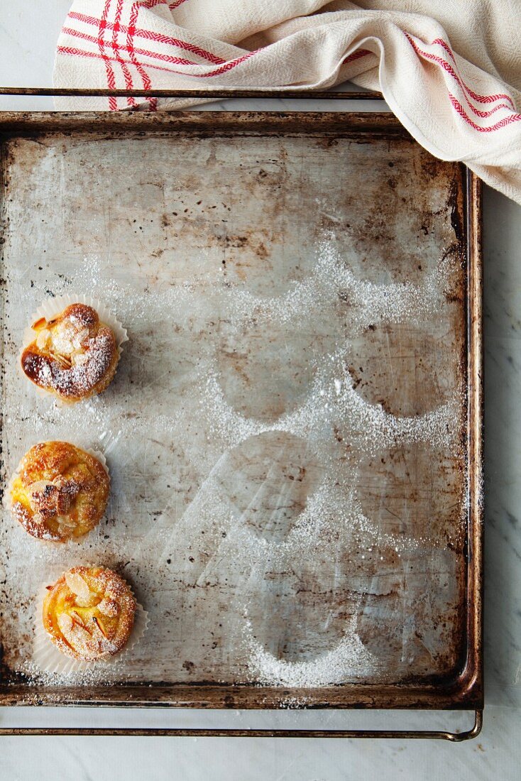 Saffron tartlets with oranges on a baking tray