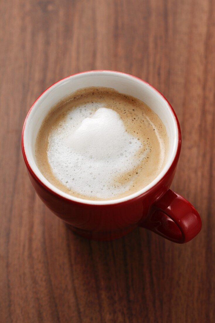 A cup of coffee with frothed milk