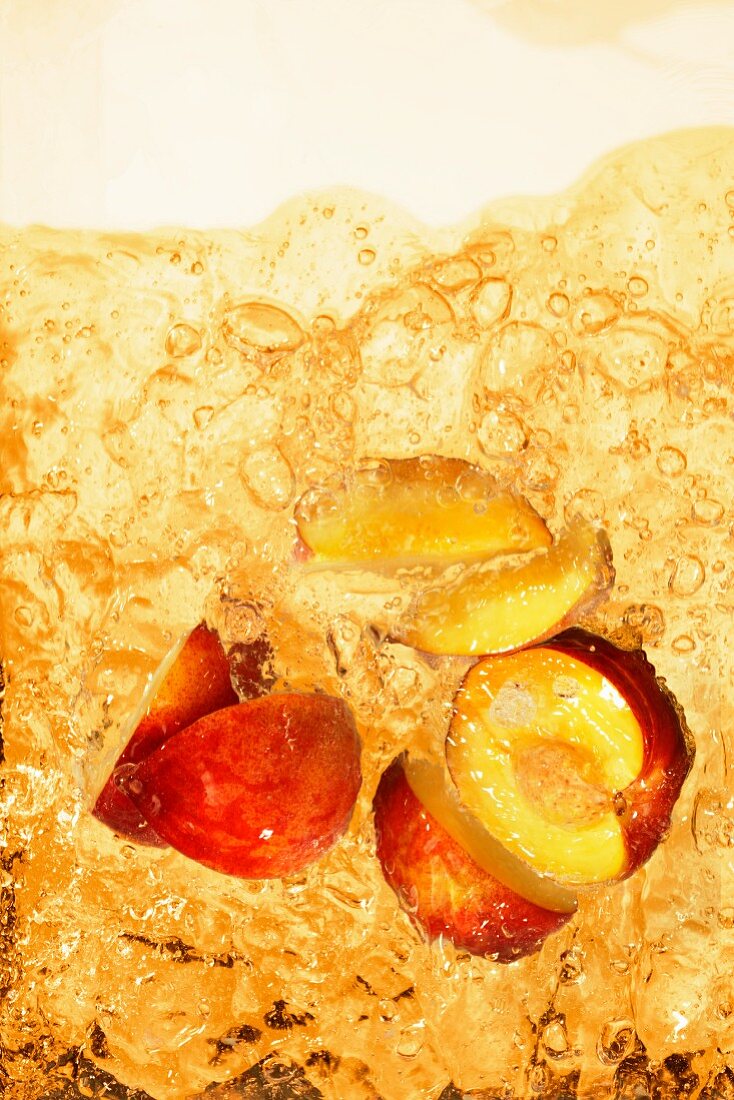 Peach iced tea with chunks of peach (close-up)