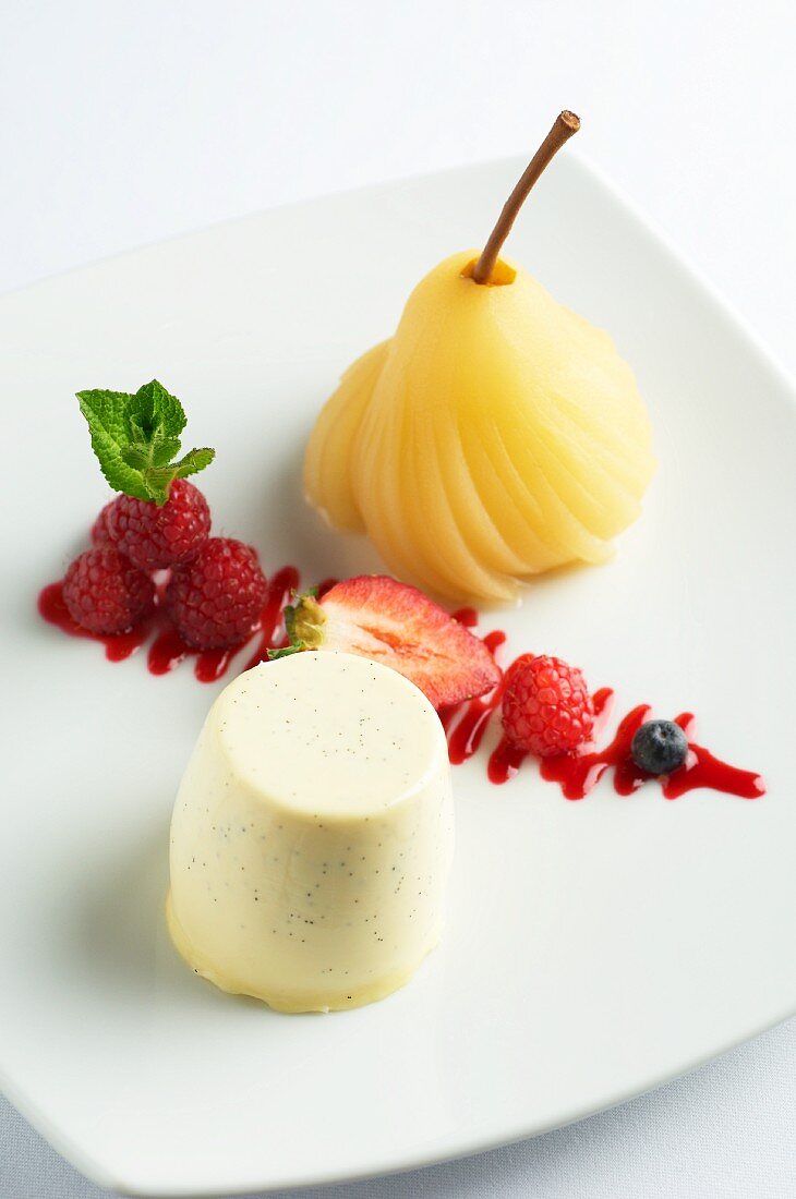 Vanilla posset with berries and a poached pear