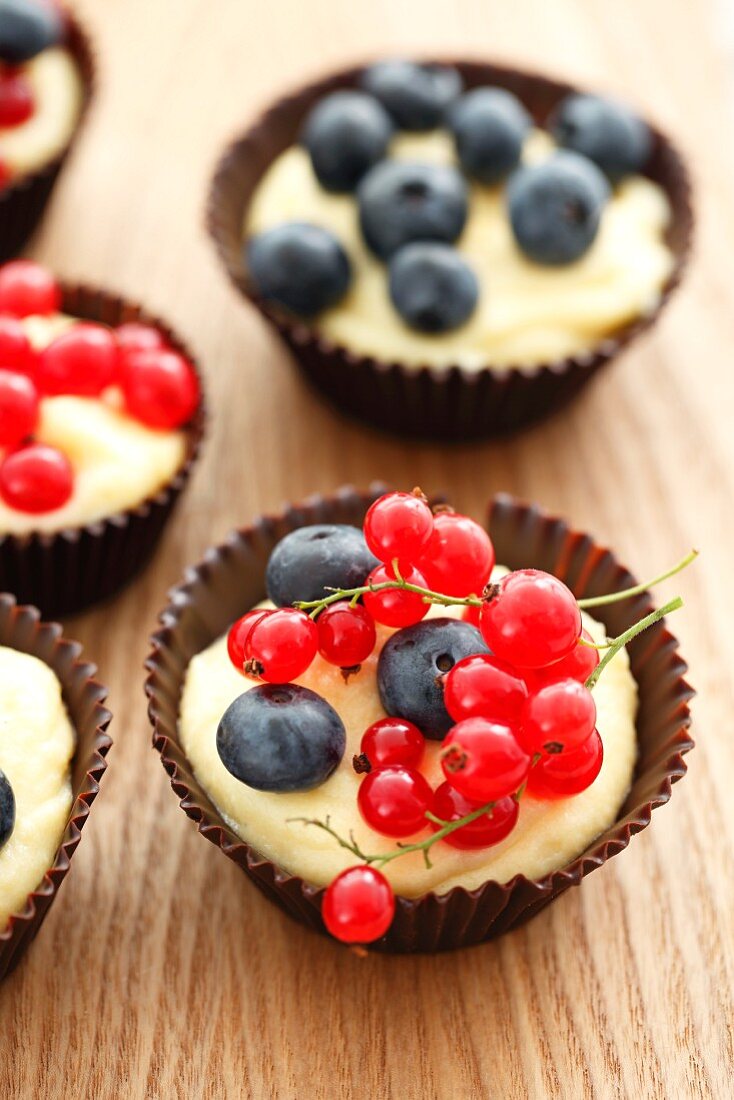 Chocolate cups filled with custard and berries