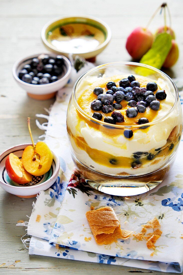 A layered dessert of quark, fruit purée and blueberries
