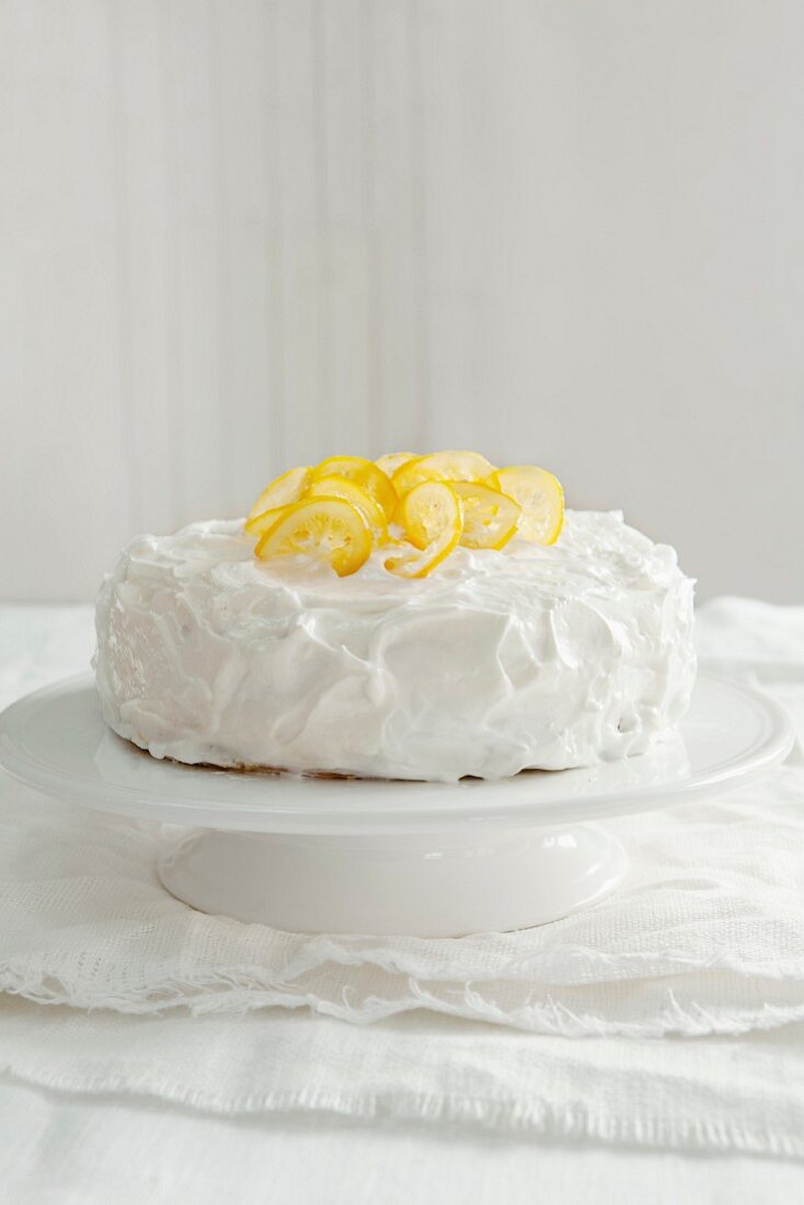 A lemon layer cake on a cake stand