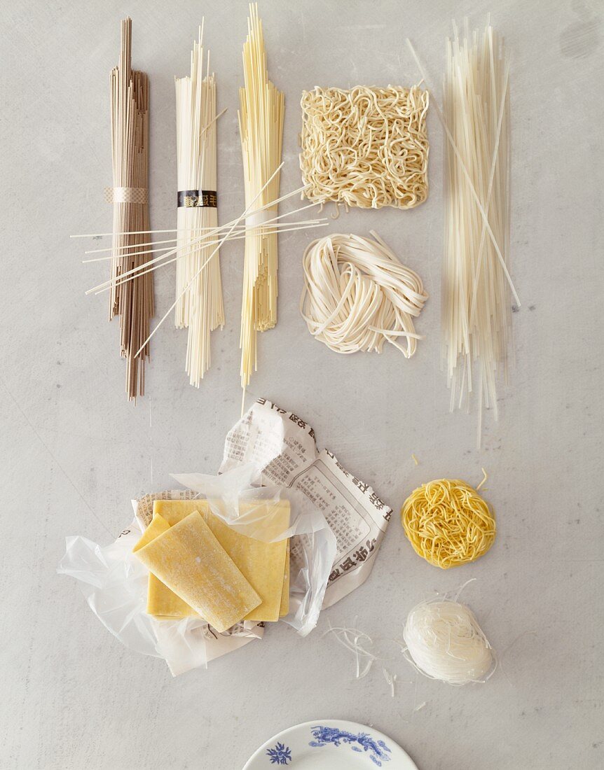 A still life featuring assorted types of Asian noodle (view from above)