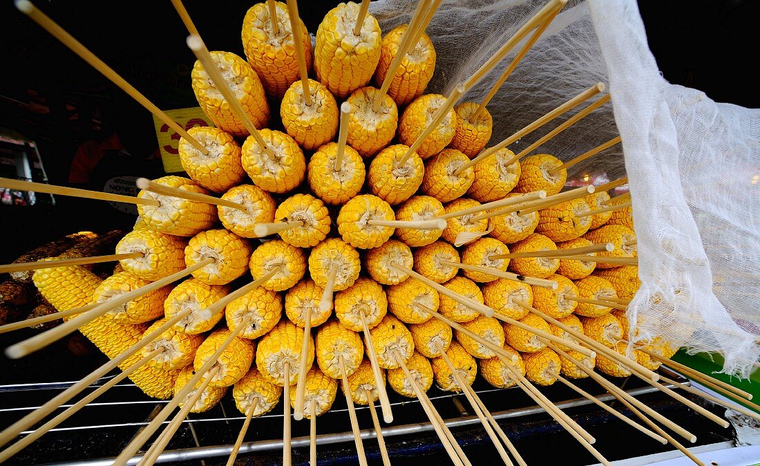 Skewered corn cobs, cooked and stacked