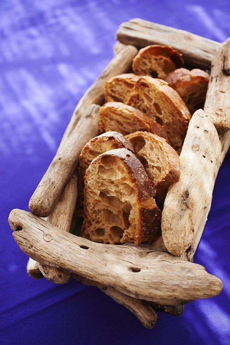 Slices of rustic bread in a wooden basket