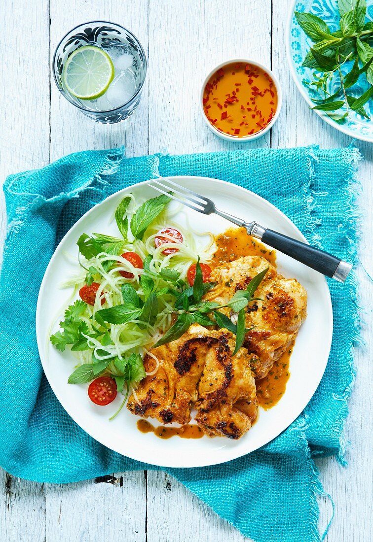 Grilled spring chicken with a side salad (Thailand)