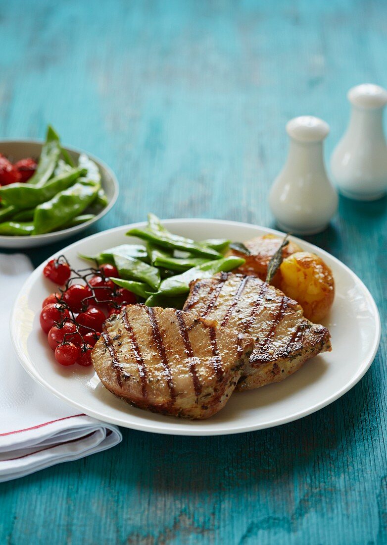 Pork steaks with roasted cherry tomatoes and green beans