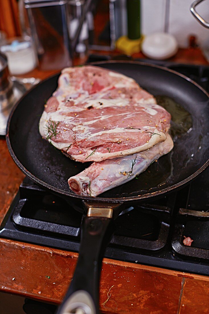 Lamb shoulder being browned in a pan